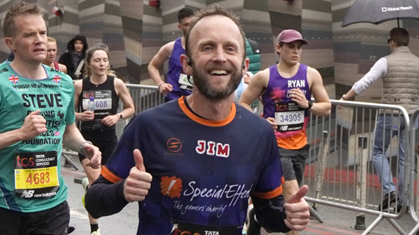 Runner in charity top gives the thumbs up